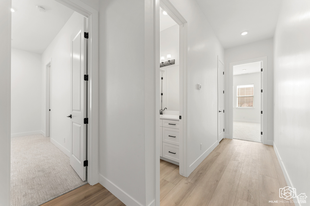 Hall featuring sink and light wood-type flooring