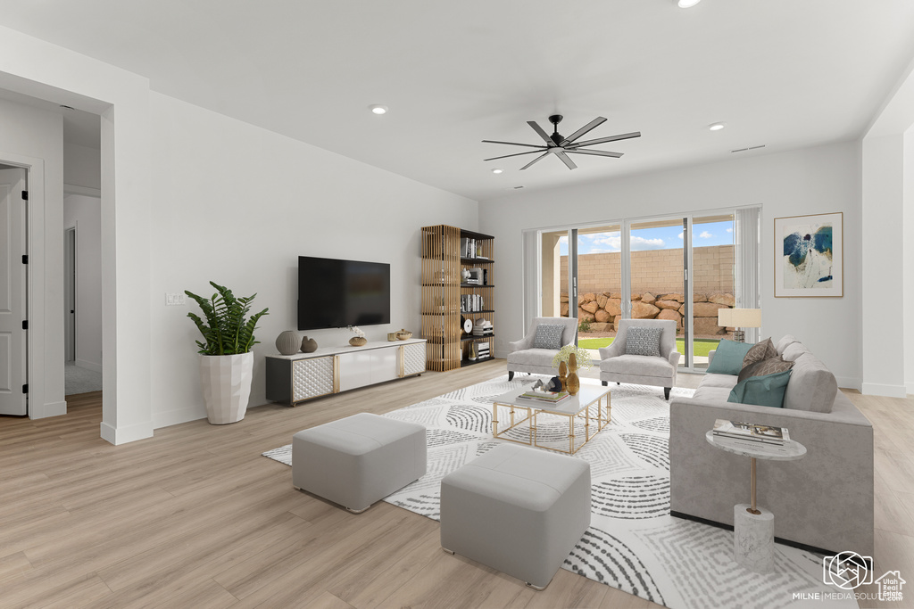 Living room with light hardwood / wood-style floors and ceiling fan