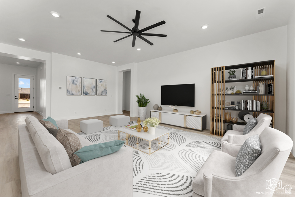 Living room featuring light hardwood / wood-style flooring and ceiling fan