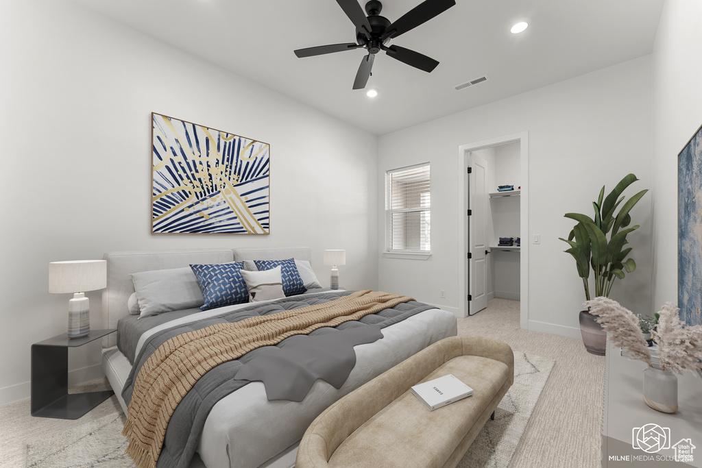 Carpeted bedroom featuring a spacious closet, a closet, and ceiling fan