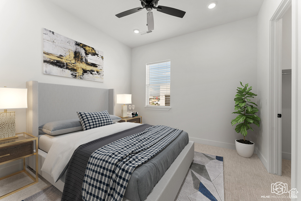 Bedroom featuring light colored carpet and ceiling fan