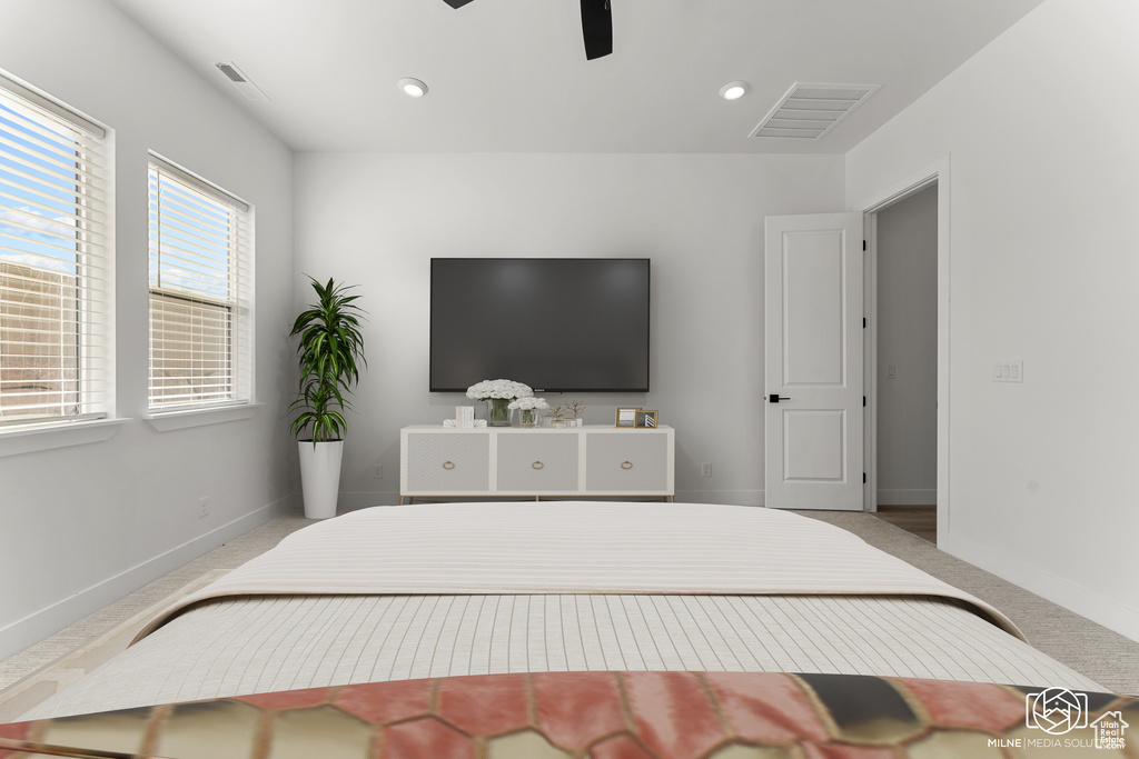 Bedroom with ceiling fan and light colored carpet