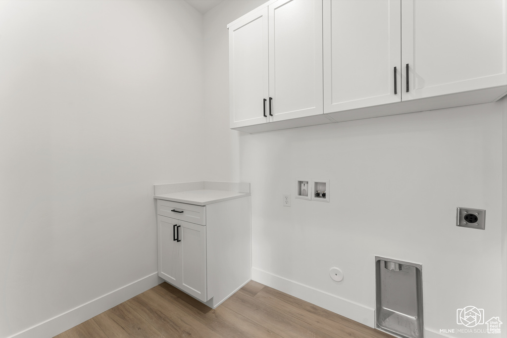 Laundry room featuring hookup for a gas dryer, hookup for an electric dryer, hookup for a washing machine, and light wood-type flooring