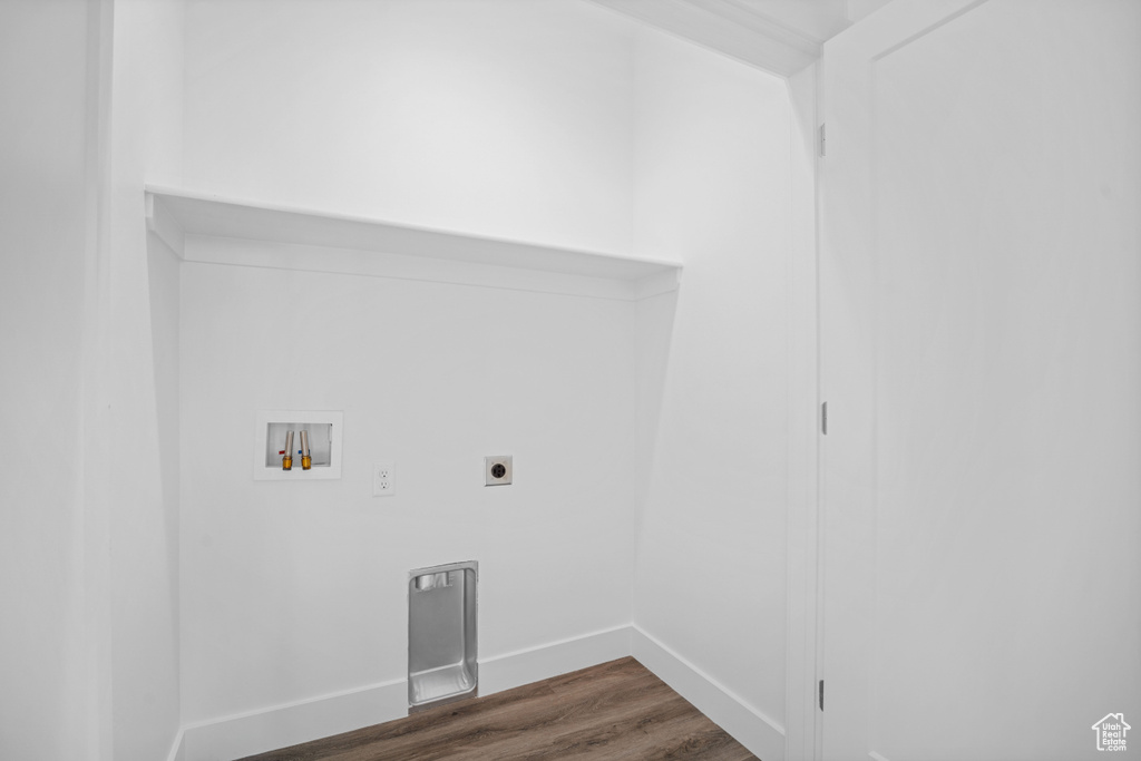 Laundry room featuring washer hookup, dark hardwood / wood-style flooring, and hookup for an electric dryer