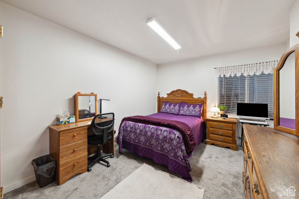 Bedroom featuring light carpet