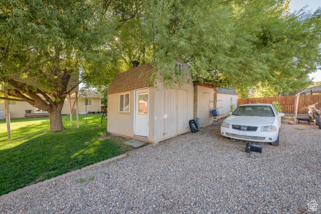 View of outdoor structure with a yard