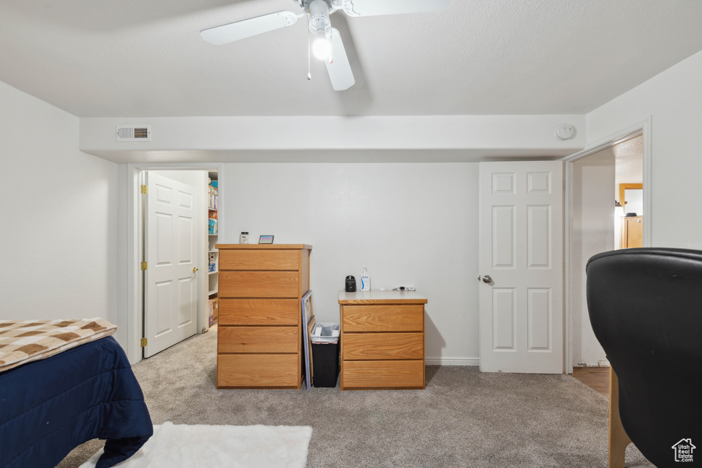 Carpeted bedroom with ceiling fan