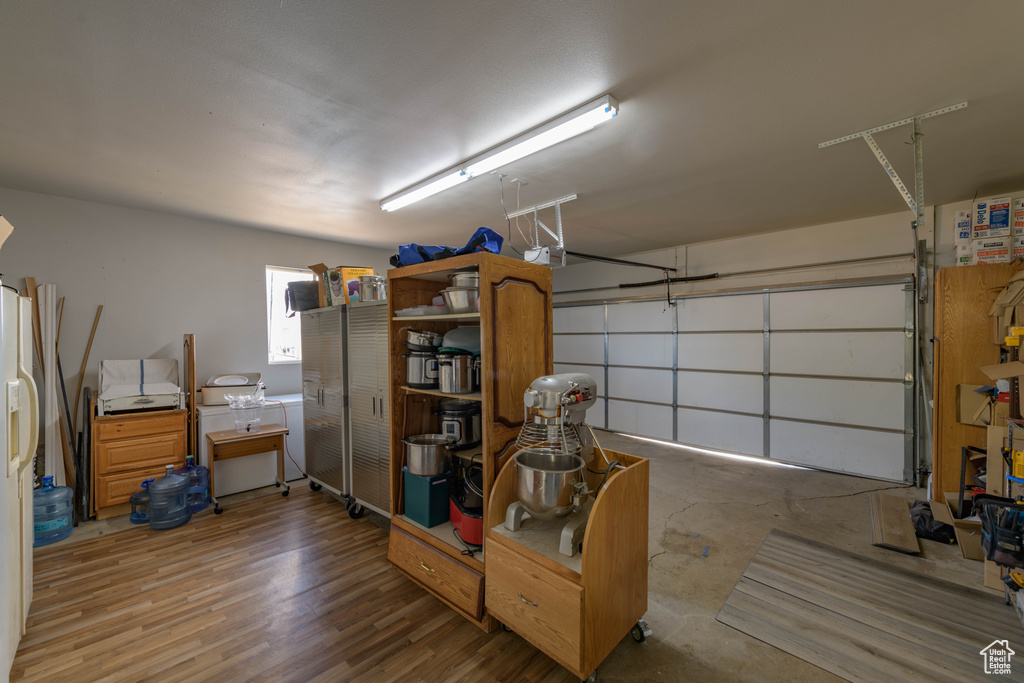 Garage featuring white fridge with ice dispenser