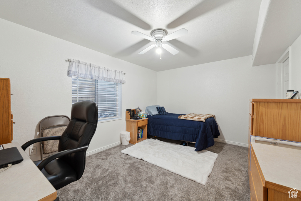 Bedroom featuring ceiling fan and light colored carpet