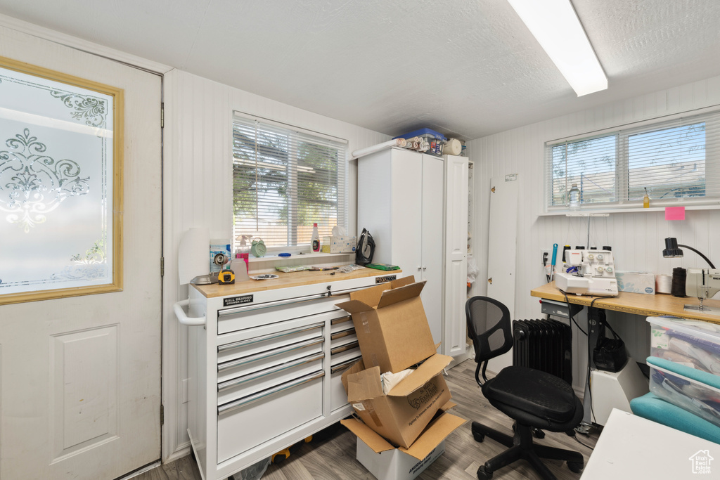 Office with hardwood / wood-style flooring, a textured ceiling, and a wealth of natural light