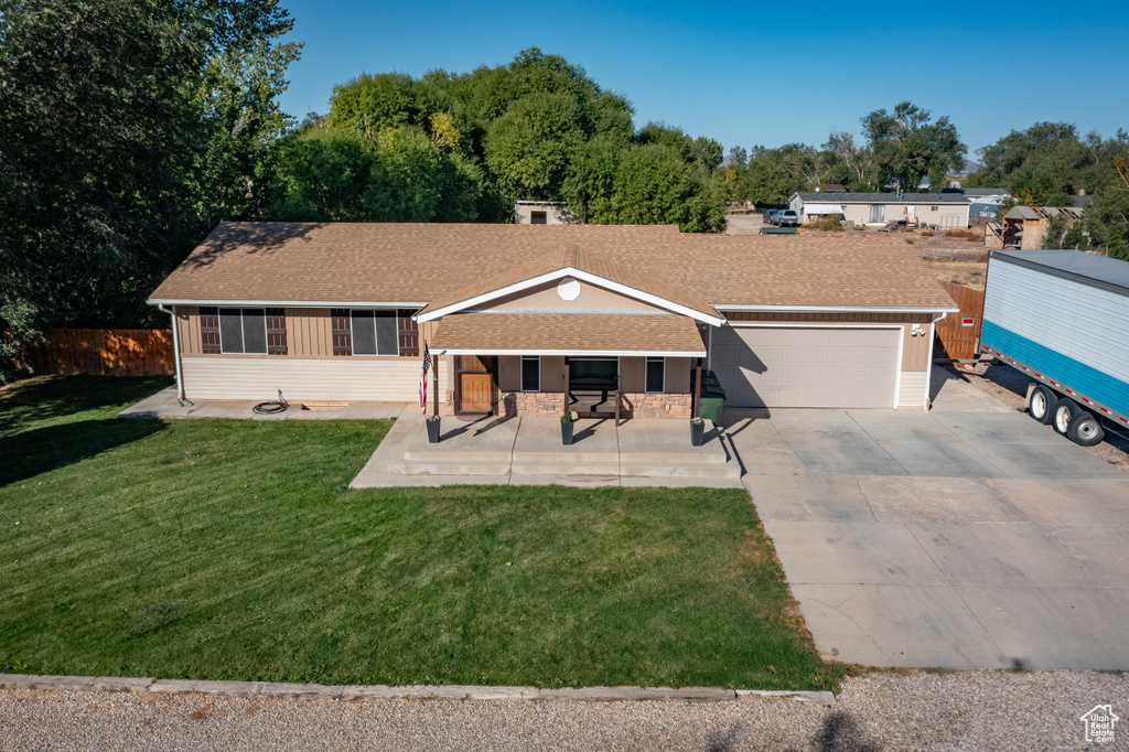 View of front facade with a garage and a front lawn