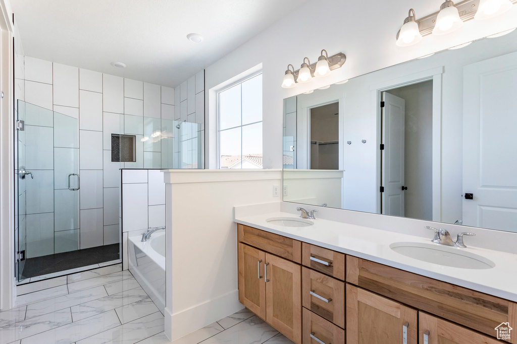 Bathroom featuring independent shower and bath and vanity