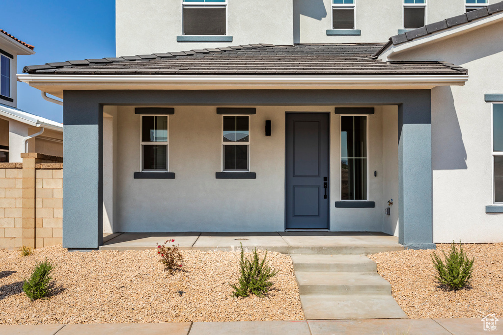 View of exterior entry with covered porch