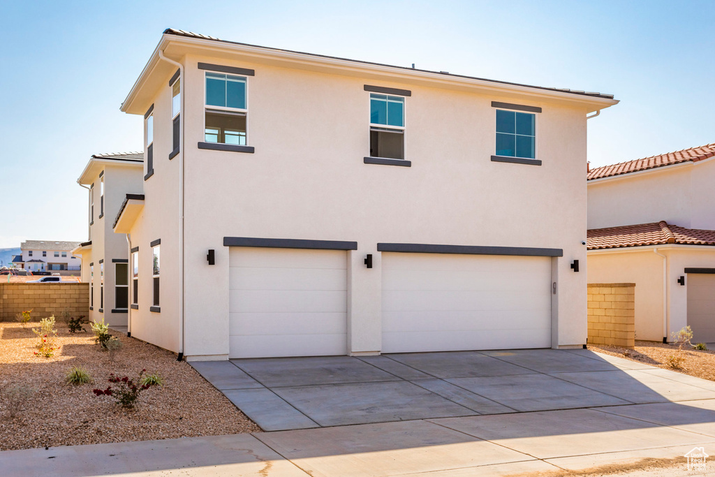 View of front facade featuring a garage