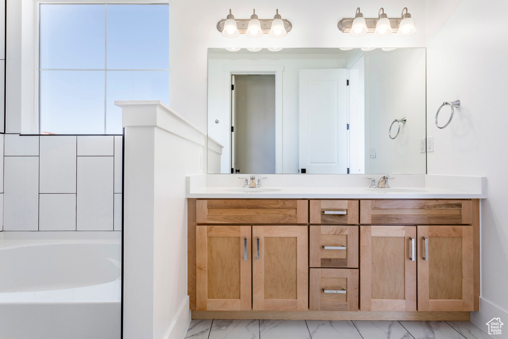 Bathroom with a bath and vanity