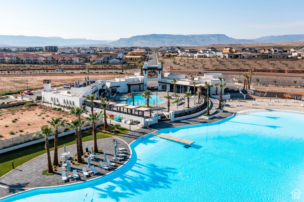 View of pool with a mountain view and a patio area