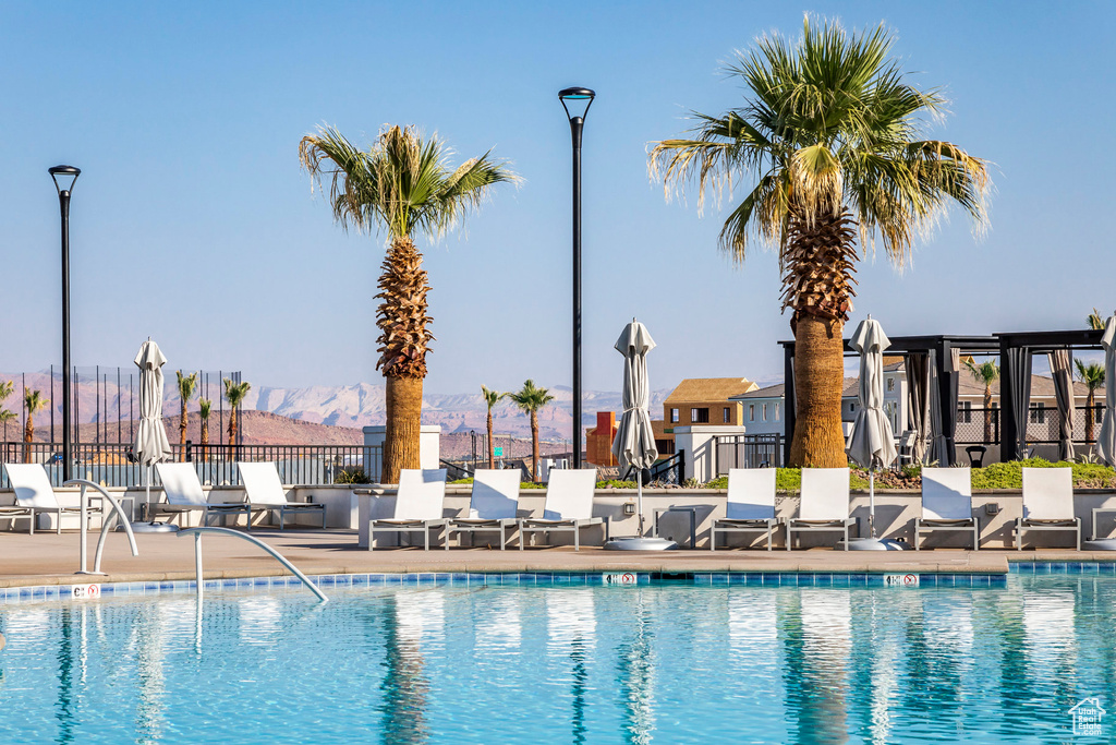 View of pool with a mountain view and a patio area