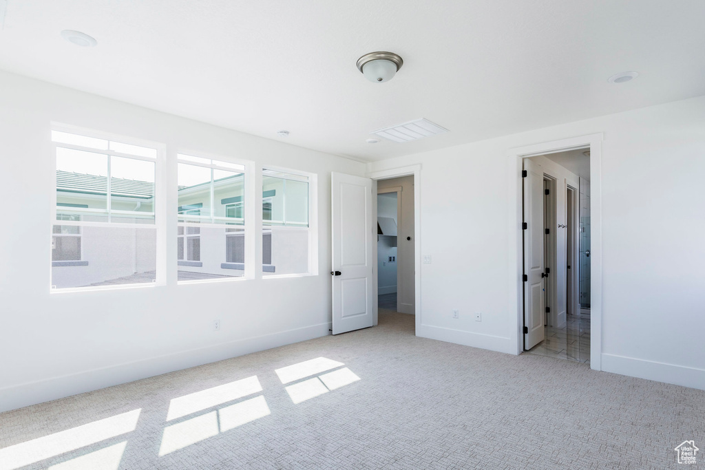 Unfurnished bedroom featuring light carpet