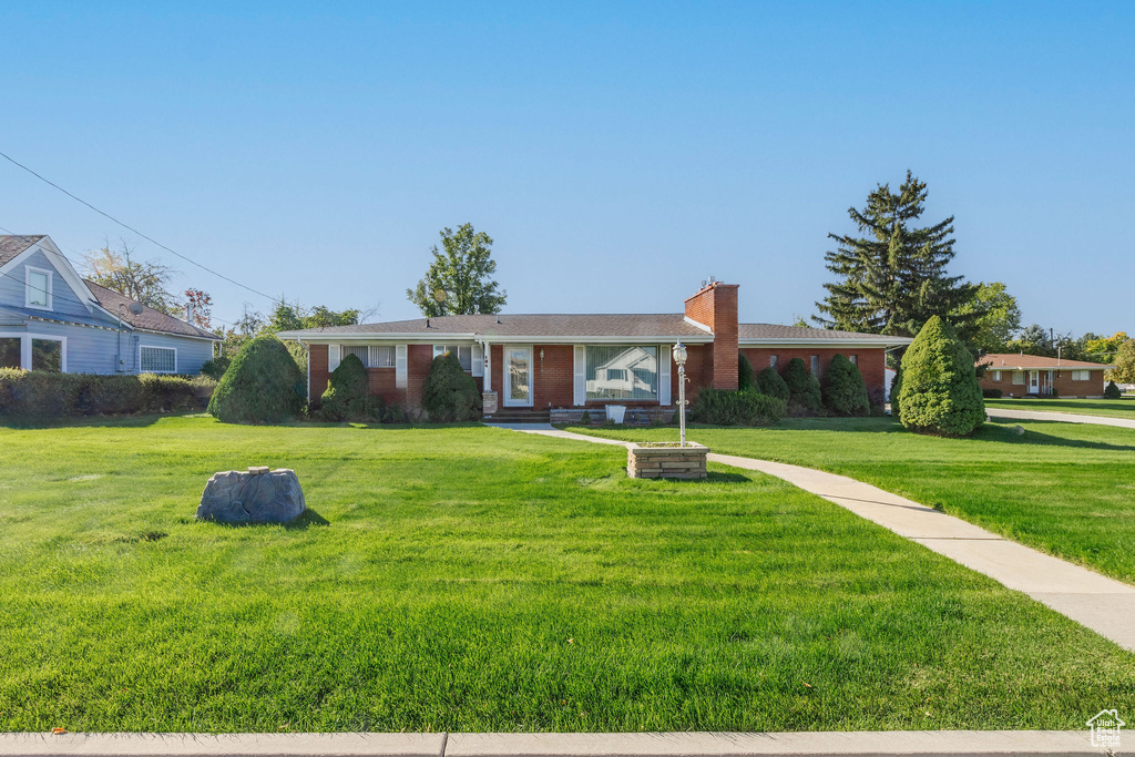 Single story home with a front lawn