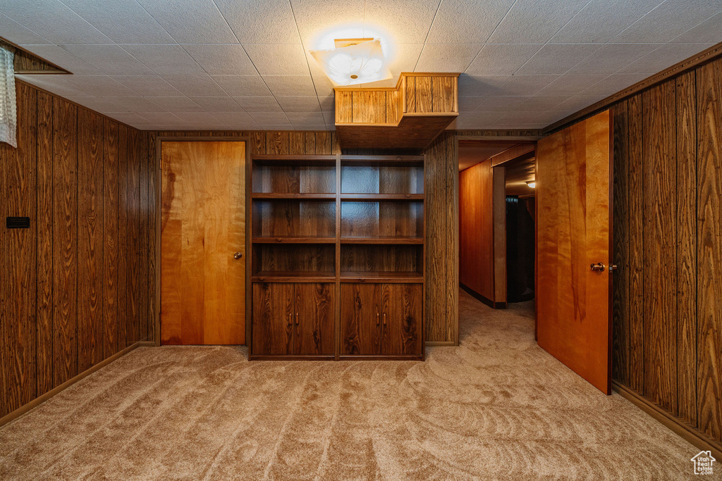 Interior space with wooden walls and light colored carpet