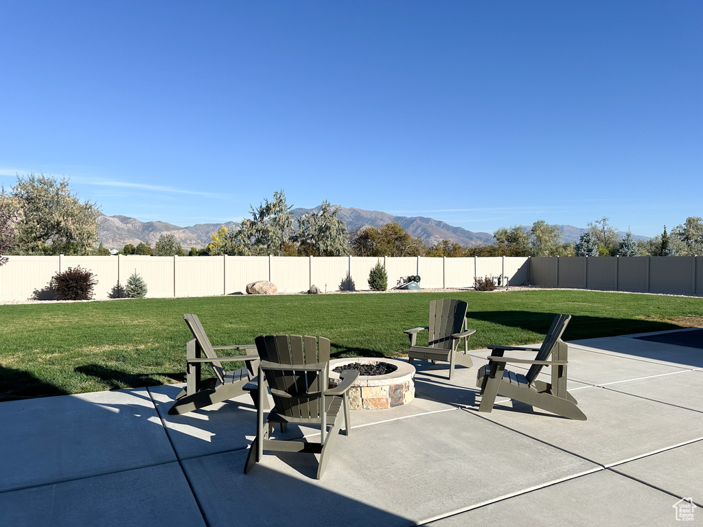 View of patio / terrace featuring a mountain view and an outdoor fire pit