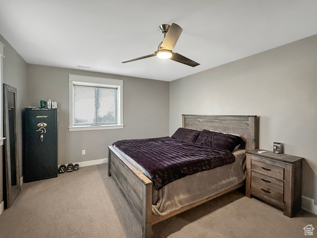 Carpeted bedroom with ceiling fan