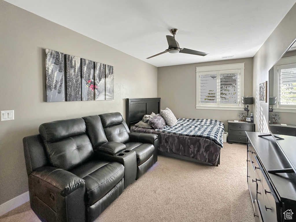 Carpeted bedroom with ceiling fan