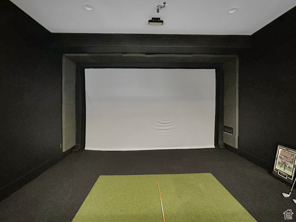 Game room with dark carpet and golf simulator