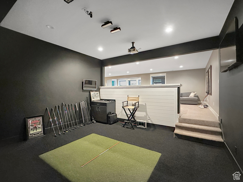 Misc room with beamed ceiling, golf simulator, and carpet flooring