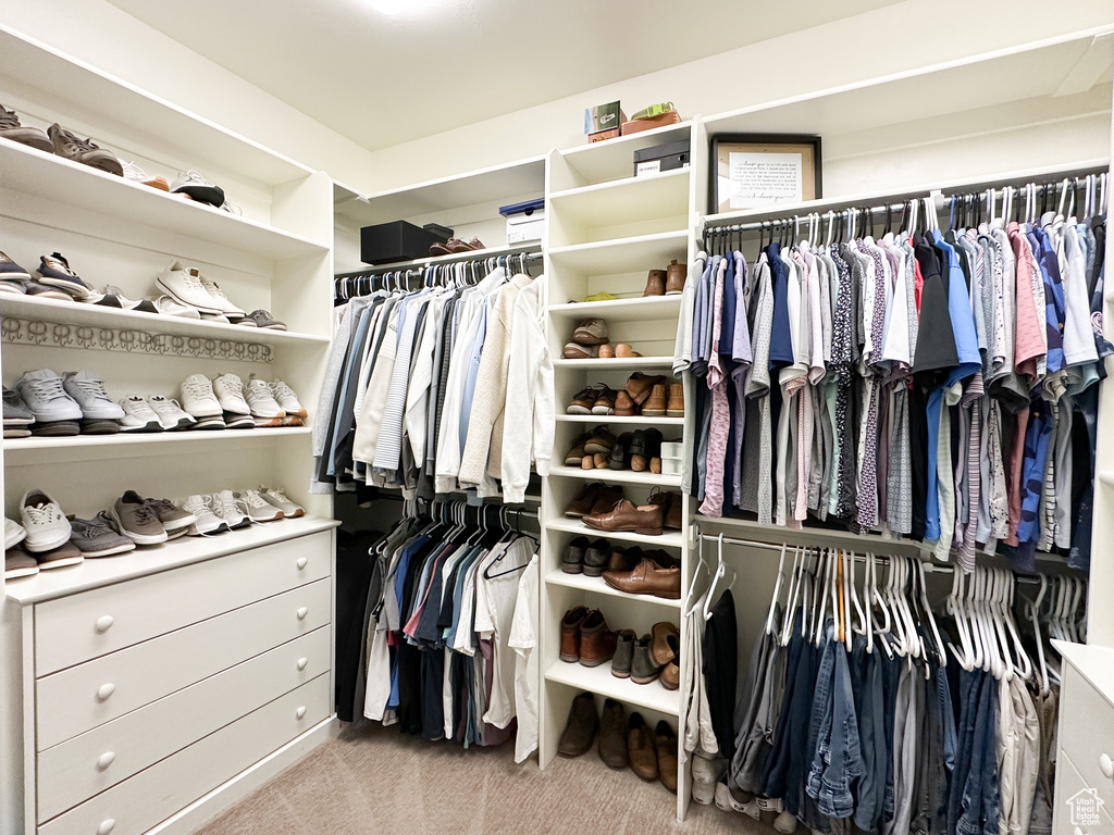 Walk in closet featuring light carpet