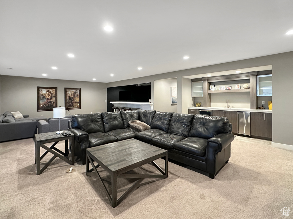 Living room with light colored carpet and wet bar