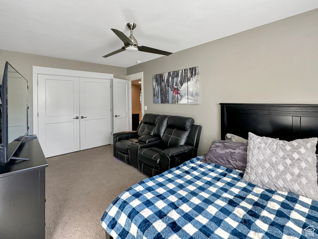 Bedroom with carpet, ceiling fan, and a closet