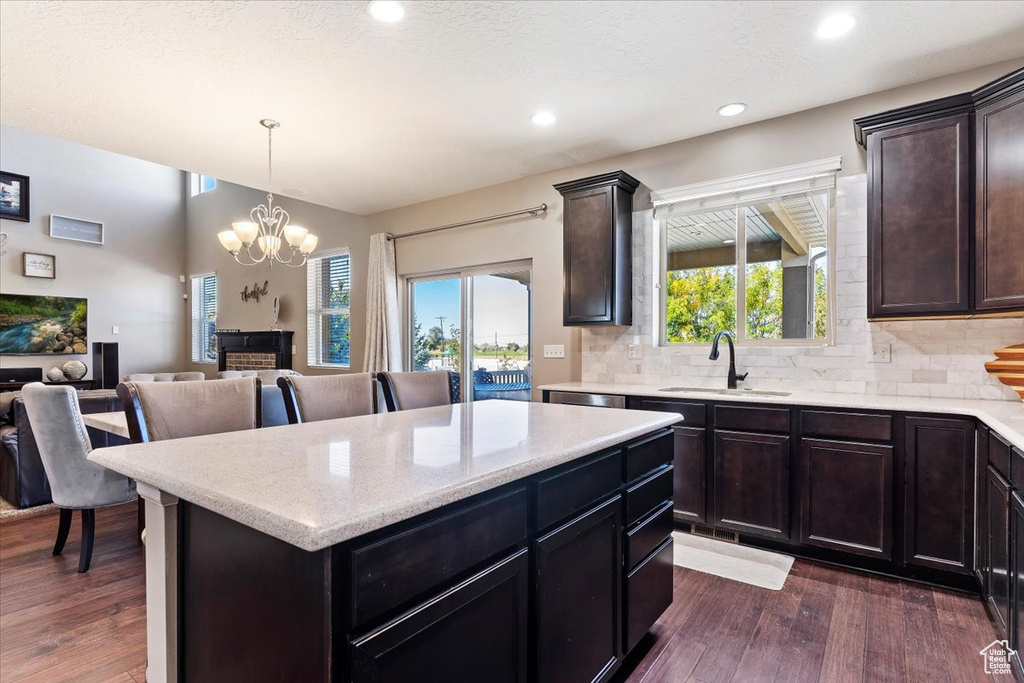 Kitchen featuring a wealth of natural light, dark wood-type flooring, and sink