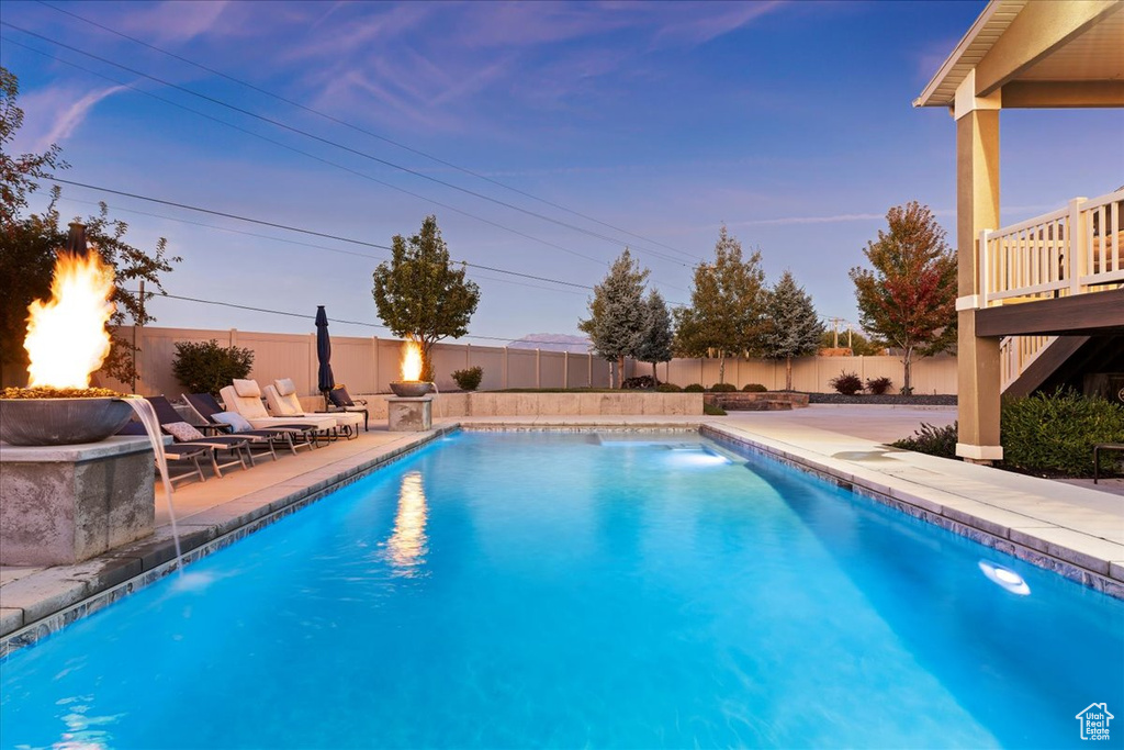 Pool at dusk with a patio area