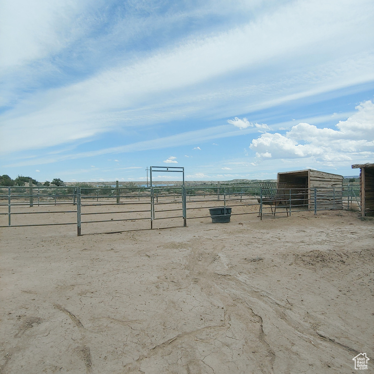 View of yard featuring a rural view and an outdoor structure