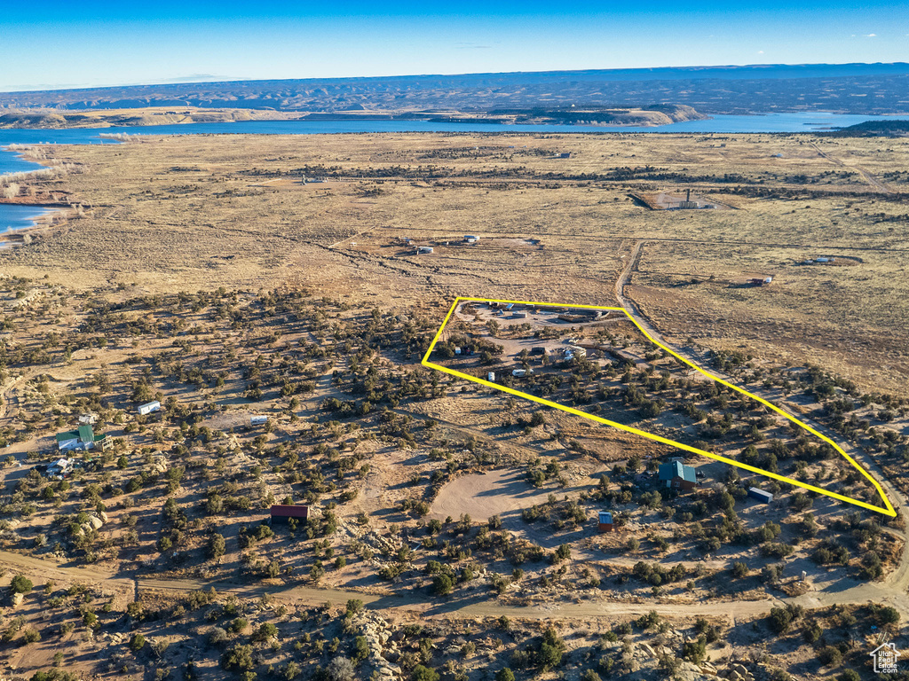 Birds eye view of property with a water view