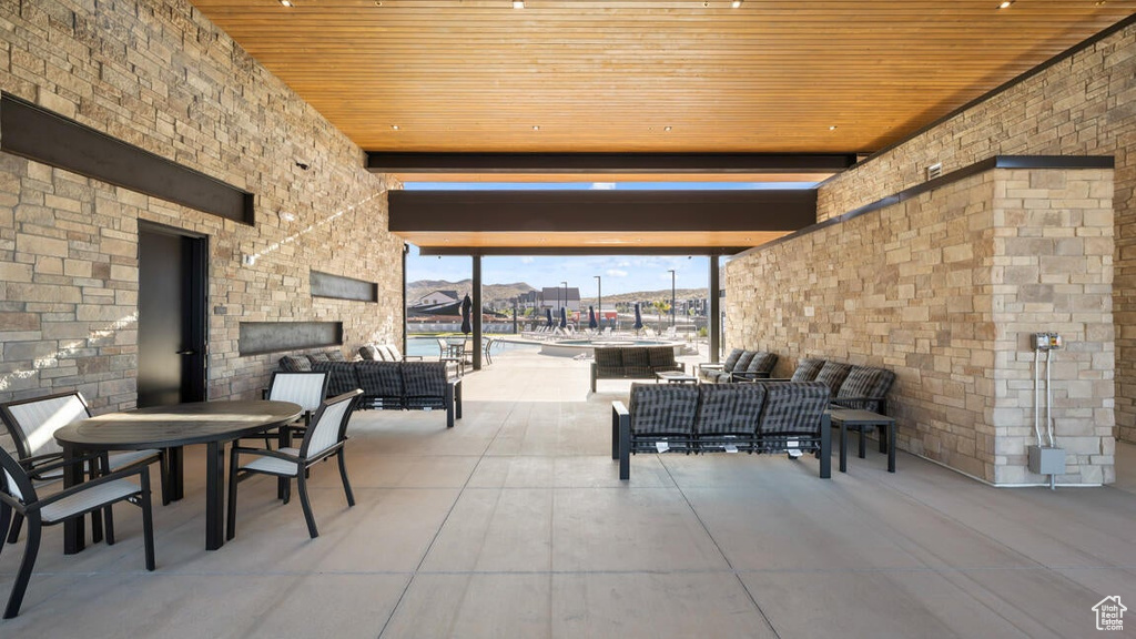 View of patio with an outdoor living space with a fireplace