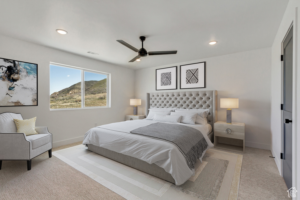 Carpeted bedroom with ceiling fan