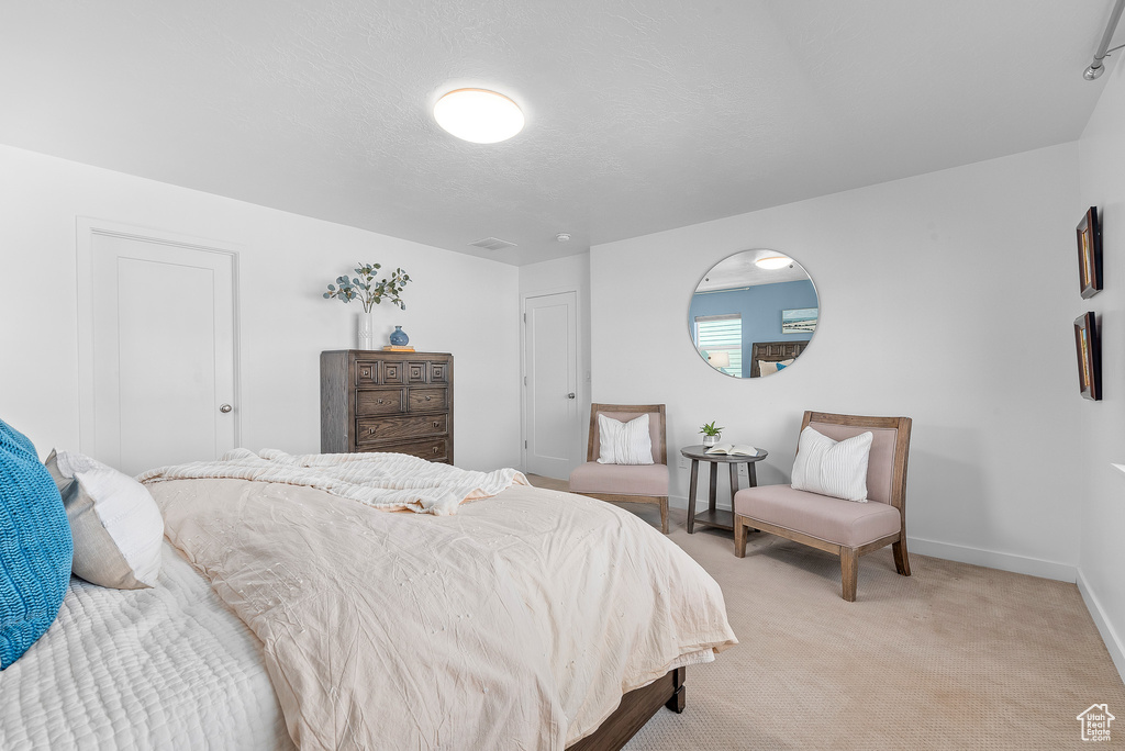 Bedroom with light carpet