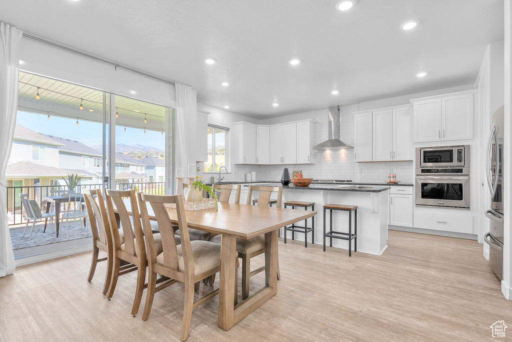 Dining space featuring light hardwood / wood-style flooring and sink