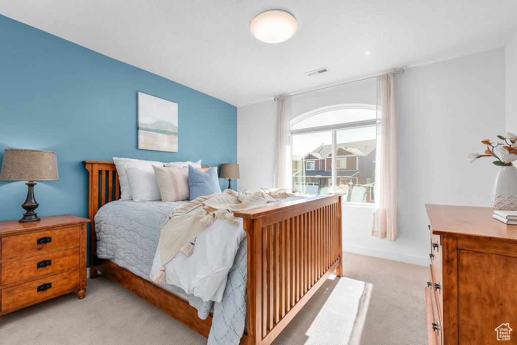 Bedroom with light carpet