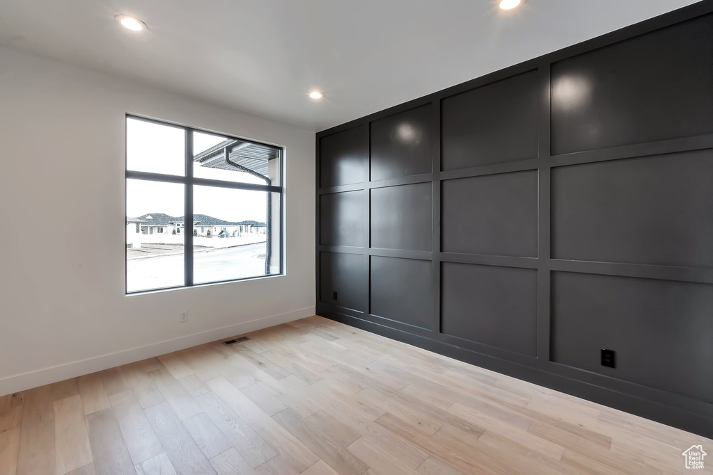 Spare room with light hardwood / wood-style floors and a wealth of natural light