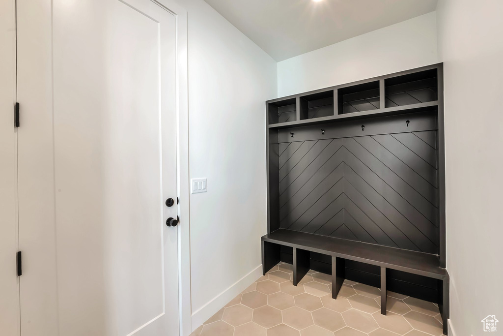 Mudroom with light tile patterned flooring