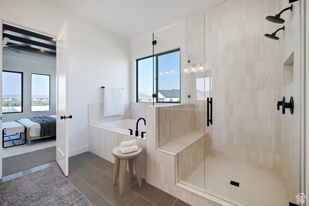 Bathroom with plus walk in shower, plenty of natural light, and tile patterned flooring