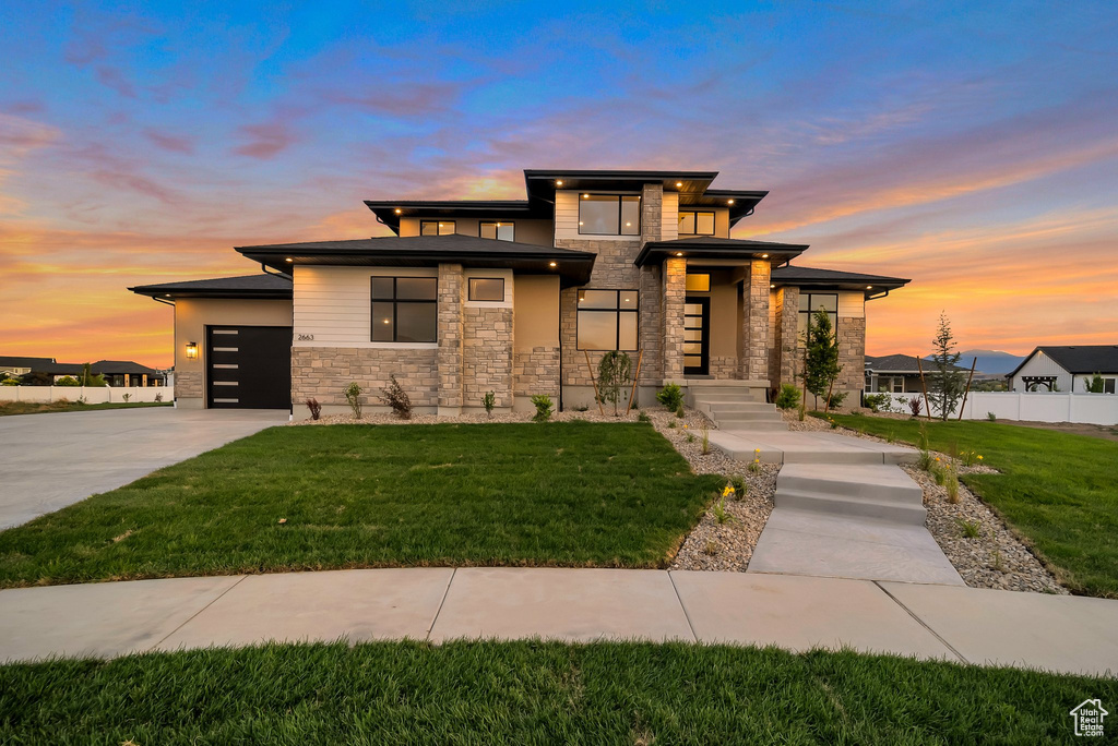 Prairie-style house with a lawn and a garage