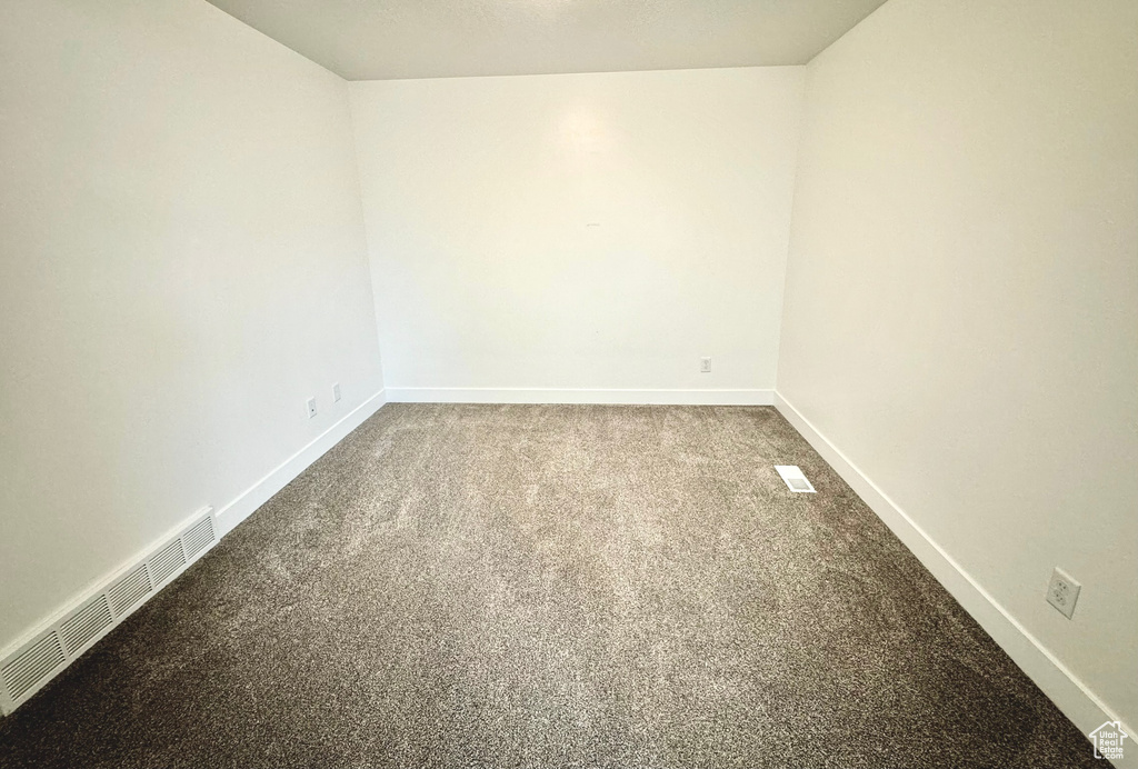 Spare room featuring carpet flooring