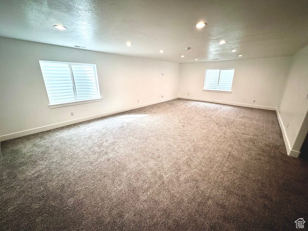 Interior space with a wealth of natural light and a textured ceiling