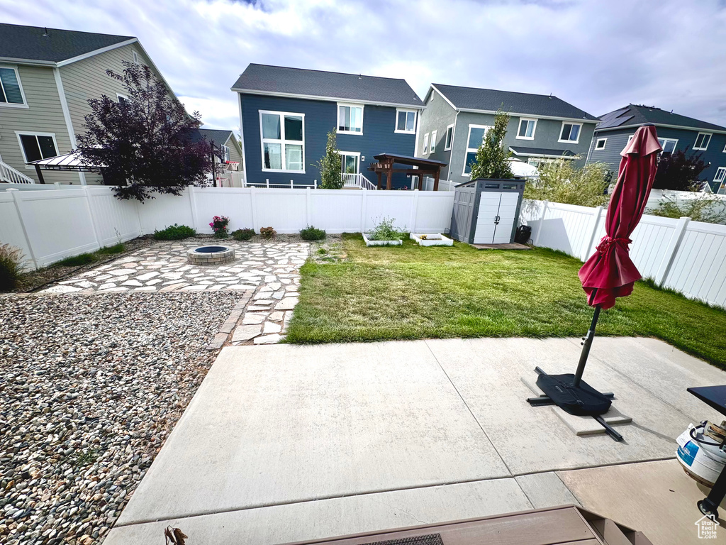 View of yard with a shed and a patio area