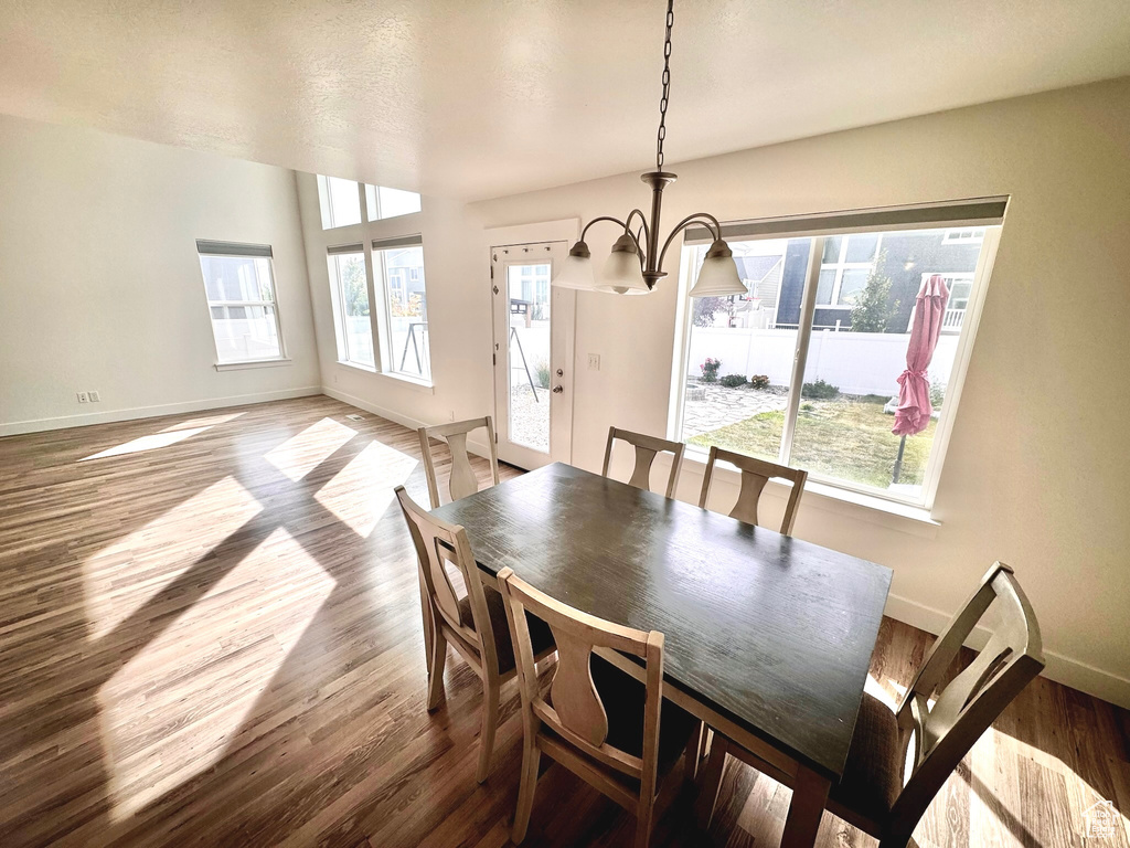 Dining room with wood-type flooring and a chandelier