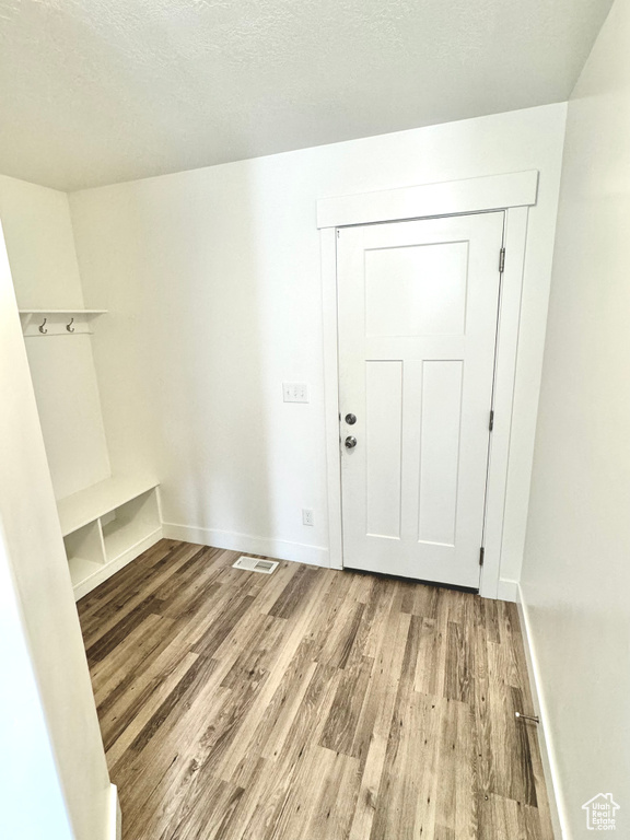 Interior space with light hardwood / wood-style flooring and a textured ceiling